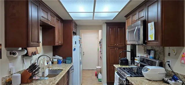 a kitchen with a sink appliances and cabinets