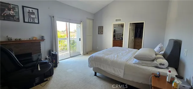 a bedroom with a bed chair and a window