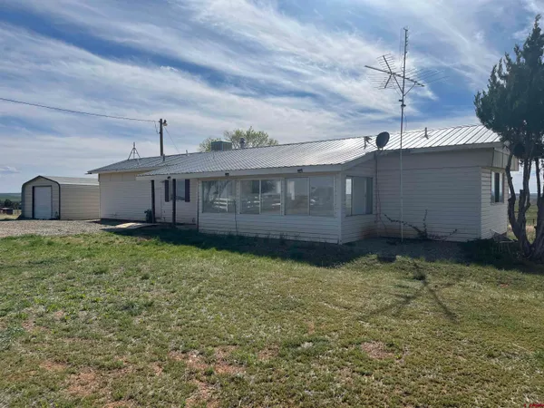 a view of a house with a backyard