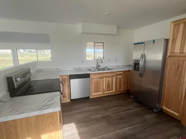a kitchen with stainless steel appliances granite countertop a sink counter space and cabinets