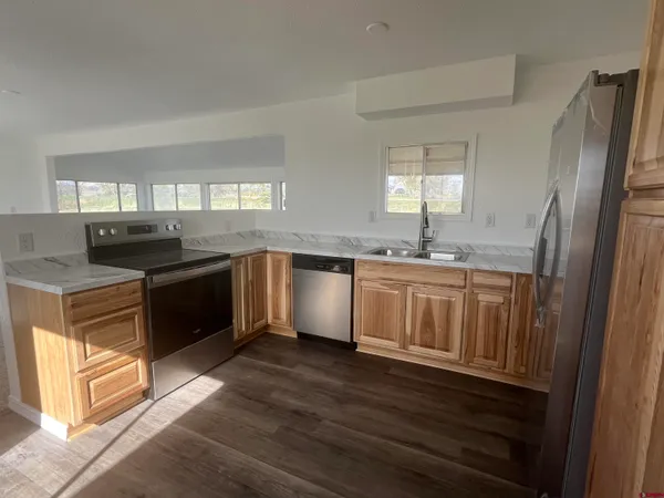 a kitchen with a sink stove and cabinets