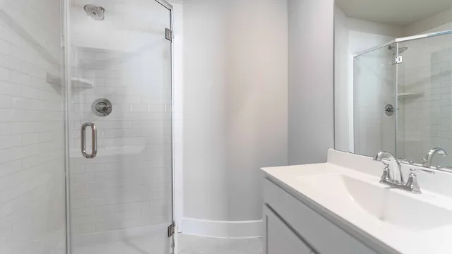 a bathroom with a granite countertop sink and shower