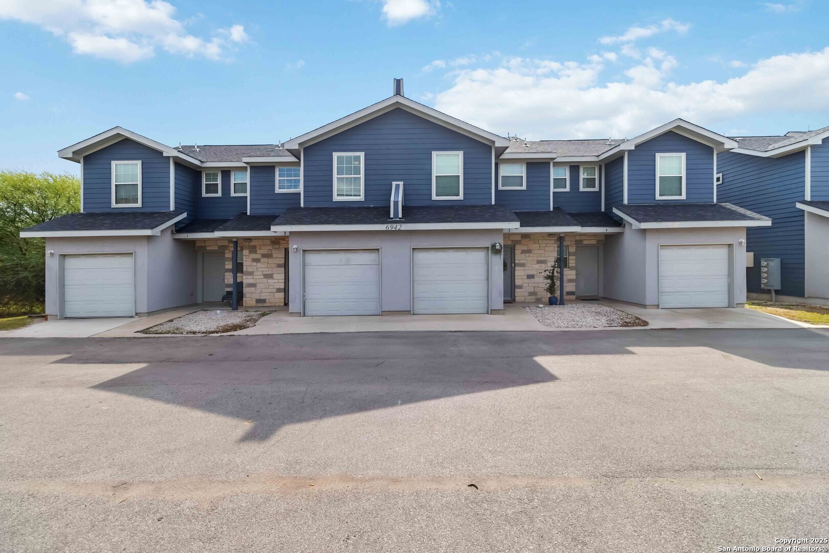 a front view of a house with a yard and parking