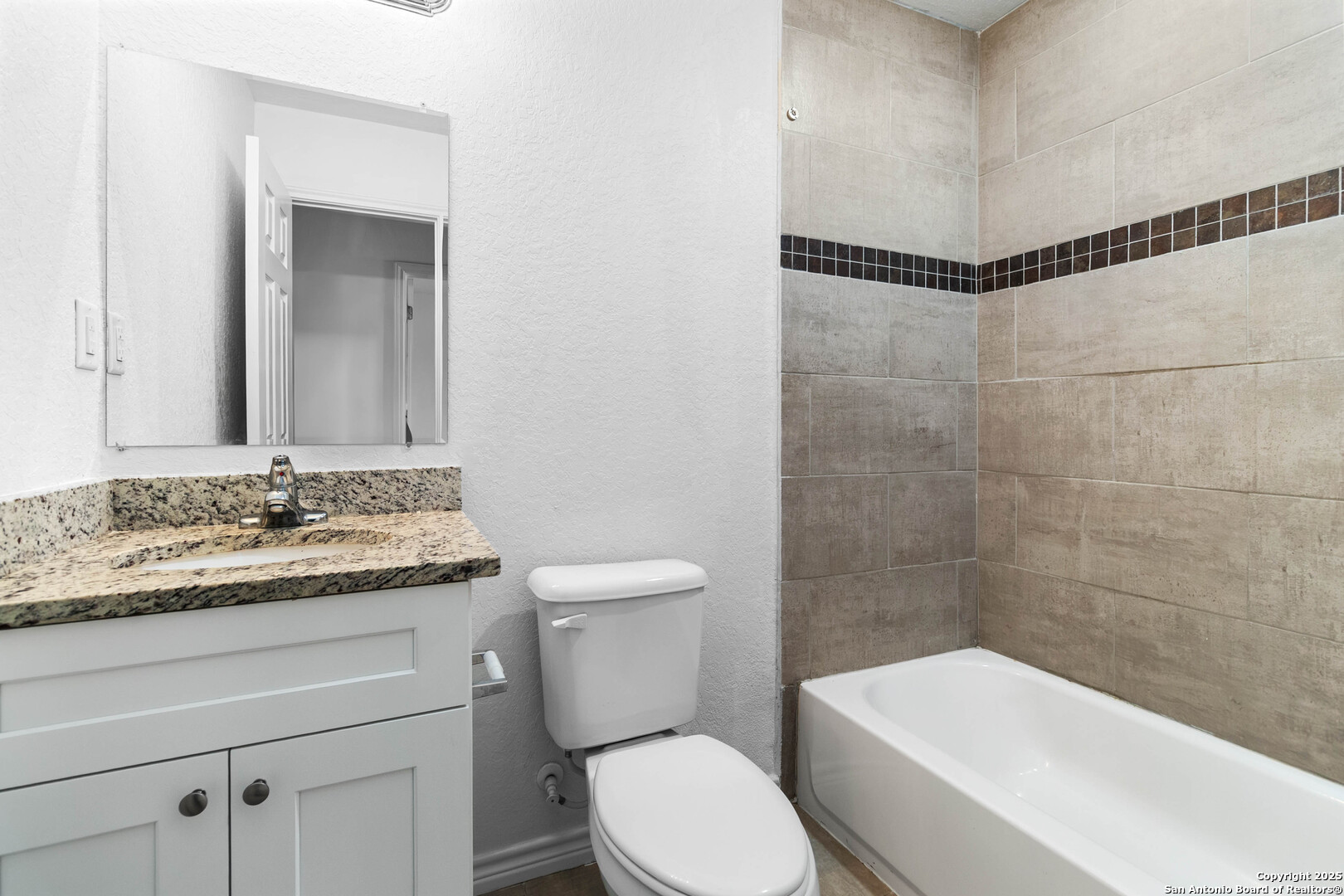 6942 Crestway Road San Antonio, TX 78239 - Photo 18 of 22 a bathroom with a sink a toilet and shower