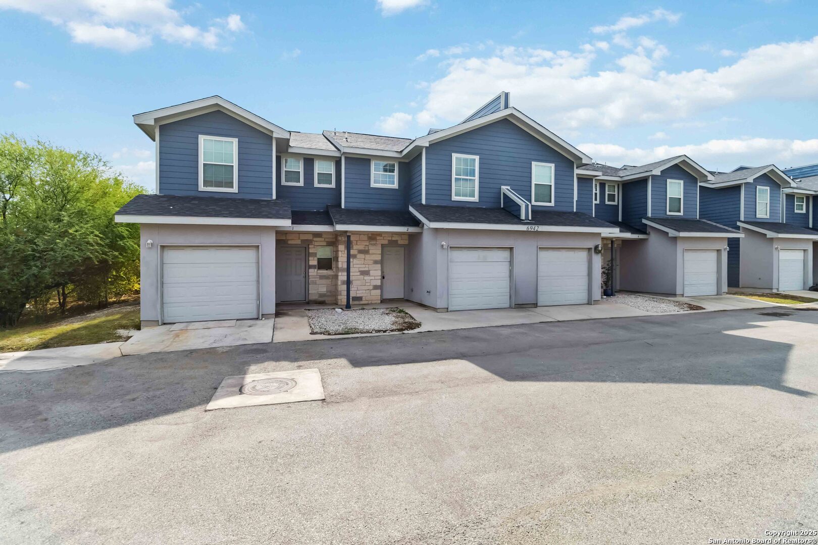 6942 Crestway Road San Antonio, TX 78239 - Photo 2 of 22 a front view of a house with a yard and garage