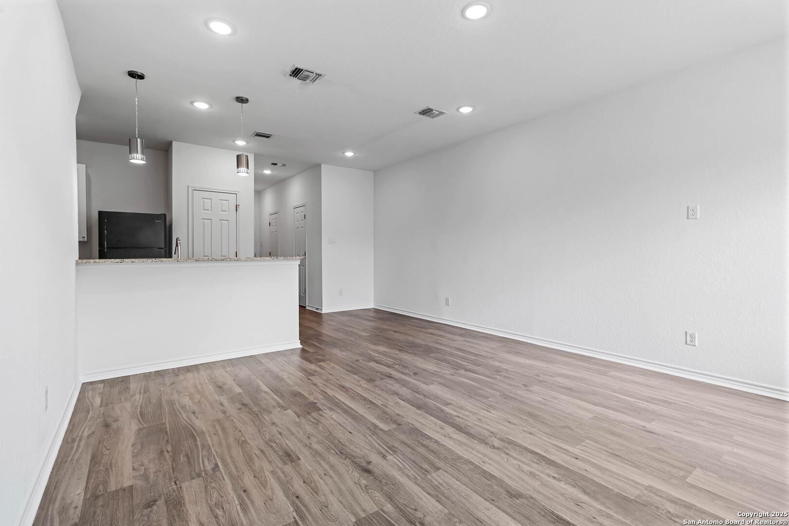 6942 Crestway Road San Antonio, TX 78239 - Photo 5 of 22 a view of an empty room with wooden floor
