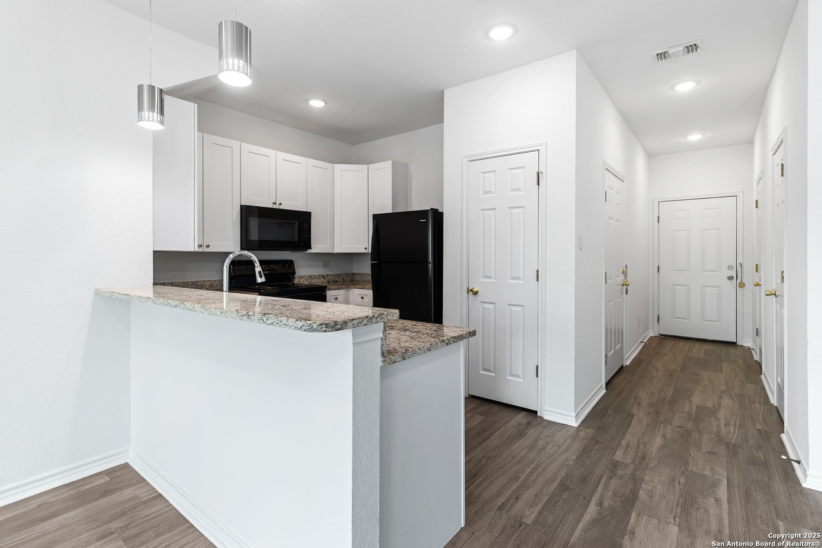 6942 Crestway Road San Antonio, TX 78239 - Photo 6 of 22 a kitchen with a refrigerator a stove and wooden floor