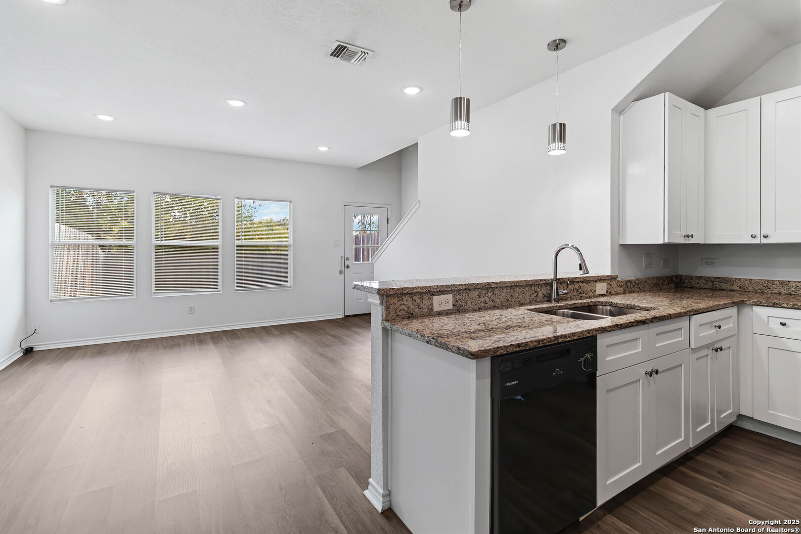 6942 Crestway Road San Antonio, TX 78239 - Photo 7 of 22 a kitchen with granite countertop a sink and stove top oven