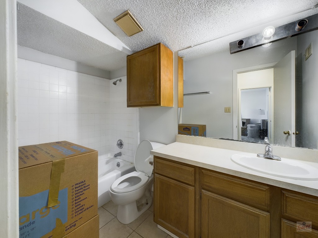 2110 Rio Grande Street, Unit 301 Austin, TX 78705 - Photo 11 of 16 a bathroom with a toilet a sink and mirror