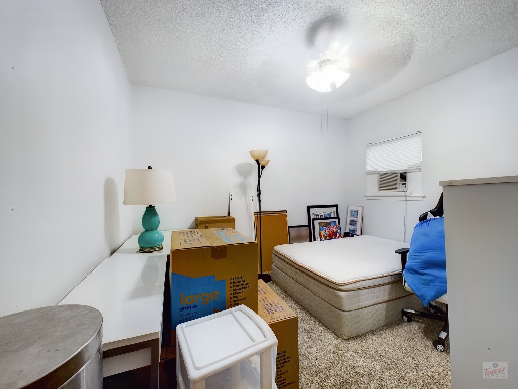 2110 Rio Grande Street, Unit 301 Austin, TX 78705 - Photo 12 of 16 a bed room with a bed and a chandelier