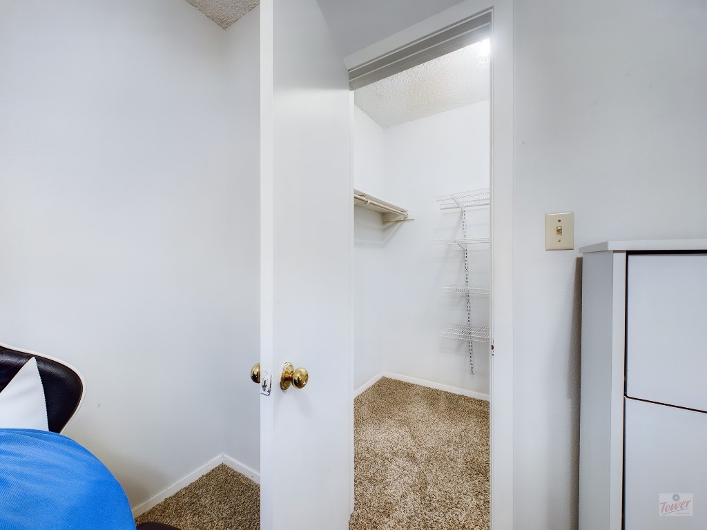 2110 Rio Grande Street, Unit 301 Austin, TX 78705 - Photo 13 of 16 a bedroom with a bed and a couch