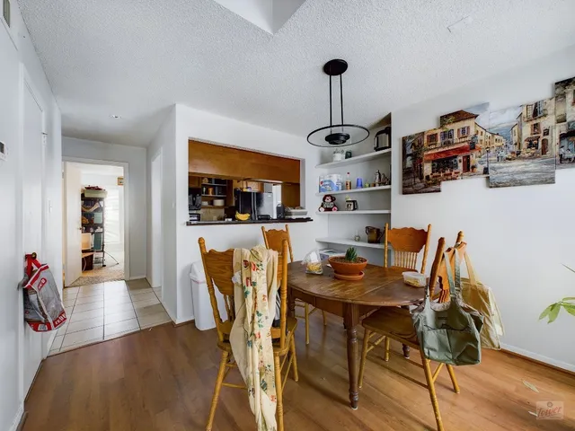a dining room with furniture and wooden floor