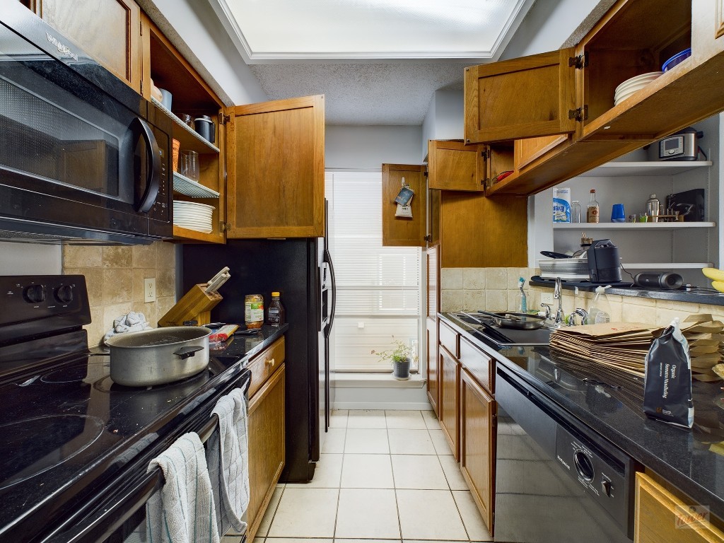 2110 Rio Grande Street, Unit 301 Austin, TX 78705 - Photo 5 of 16 a kitchen with stainless steel appliances granite countertop a stove and a sink