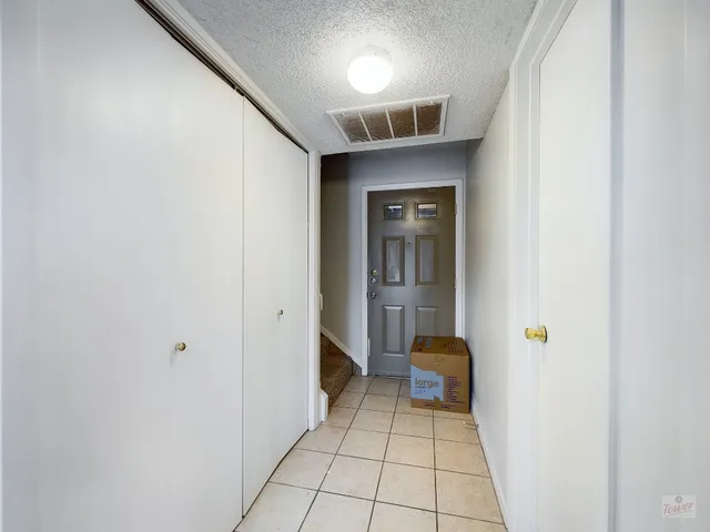 a bedroom with a bed and a lamp on dresser