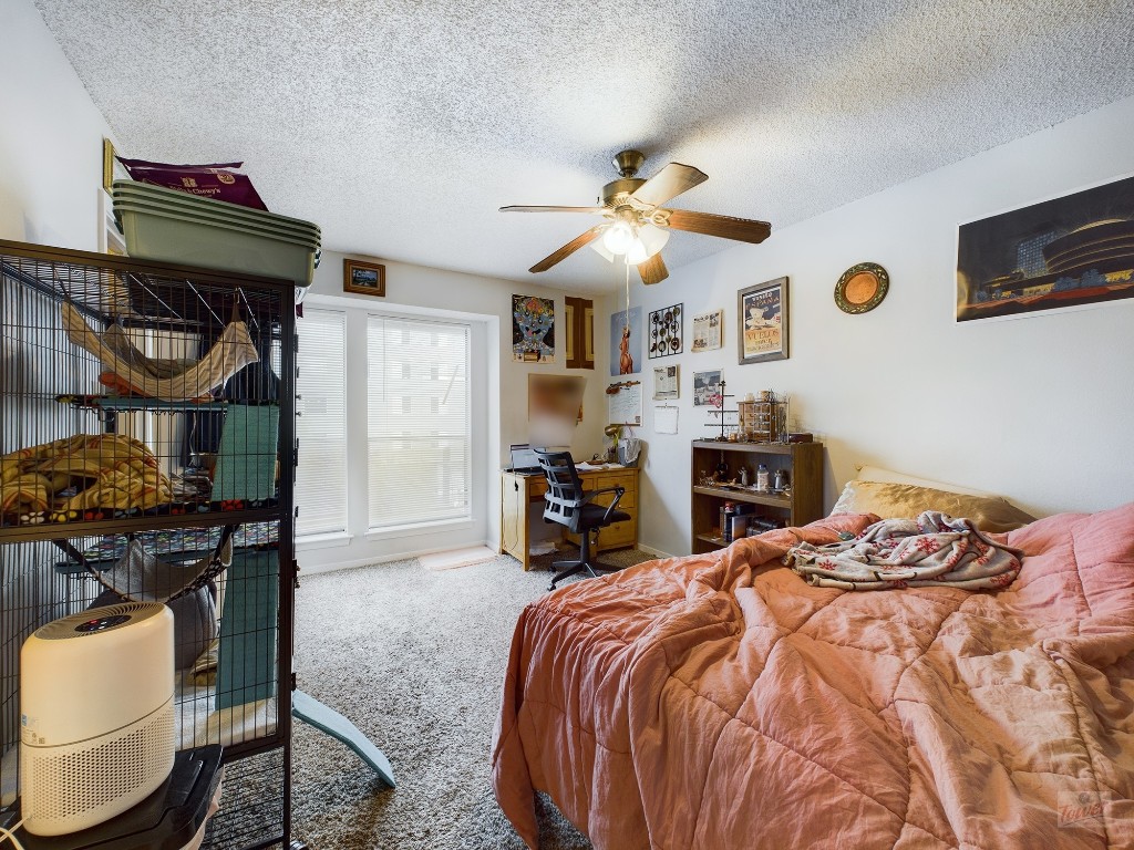 2110 Rio Grande Street, Unit 301 Austin, TX 78705 - Photo 7 of 16 a bedroom with a bed and a lamp on dresser