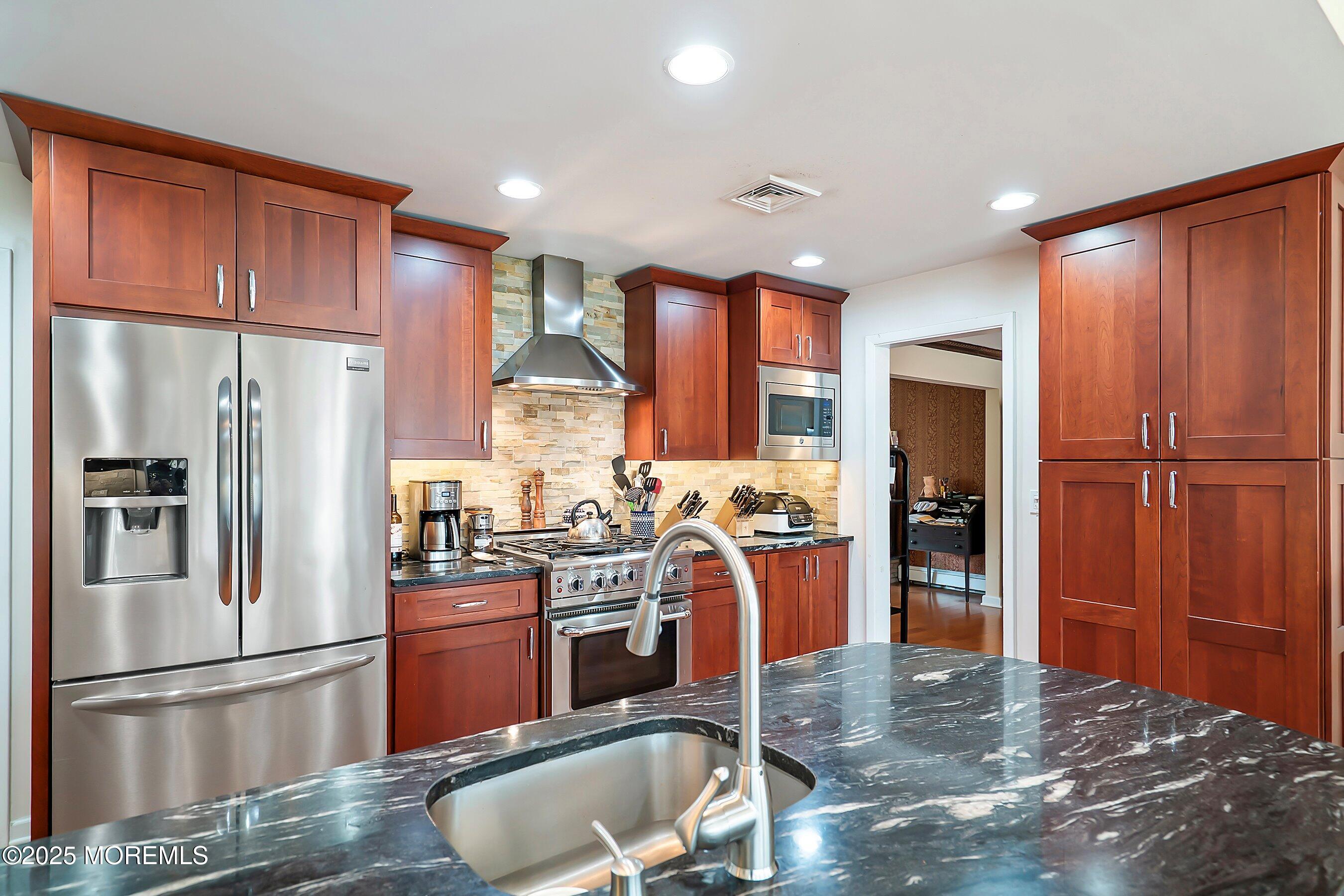 29 Holland Road Middletown, NJ 07748 - Photo 11 of 59 a kitchen with stainless steel appliances granite countertop a refrigerator stove and cabinets