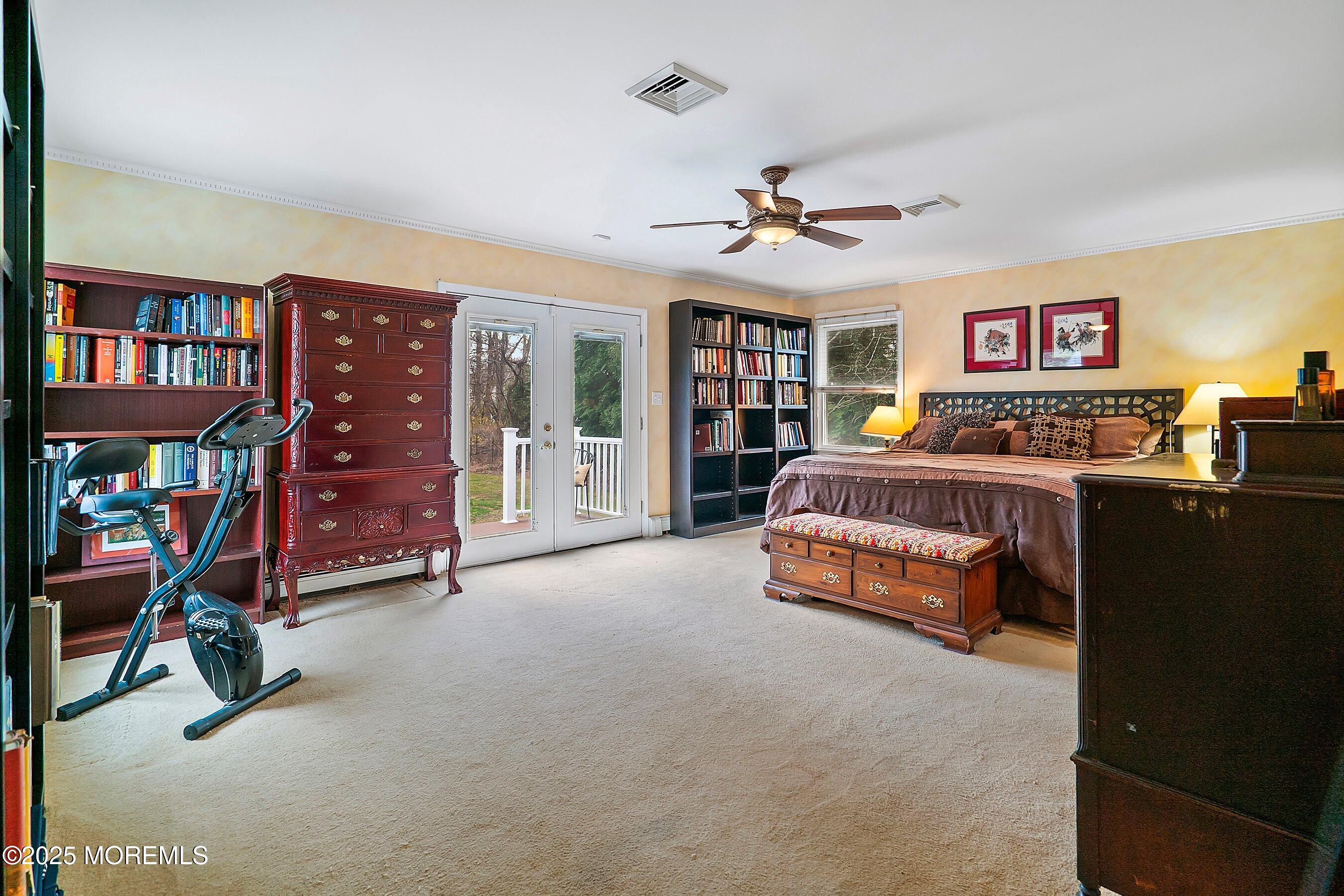 29 Holland Road Middletown, NJ 07748 - Photo 18 of 59 a bedroom with a large bed and a chandelier