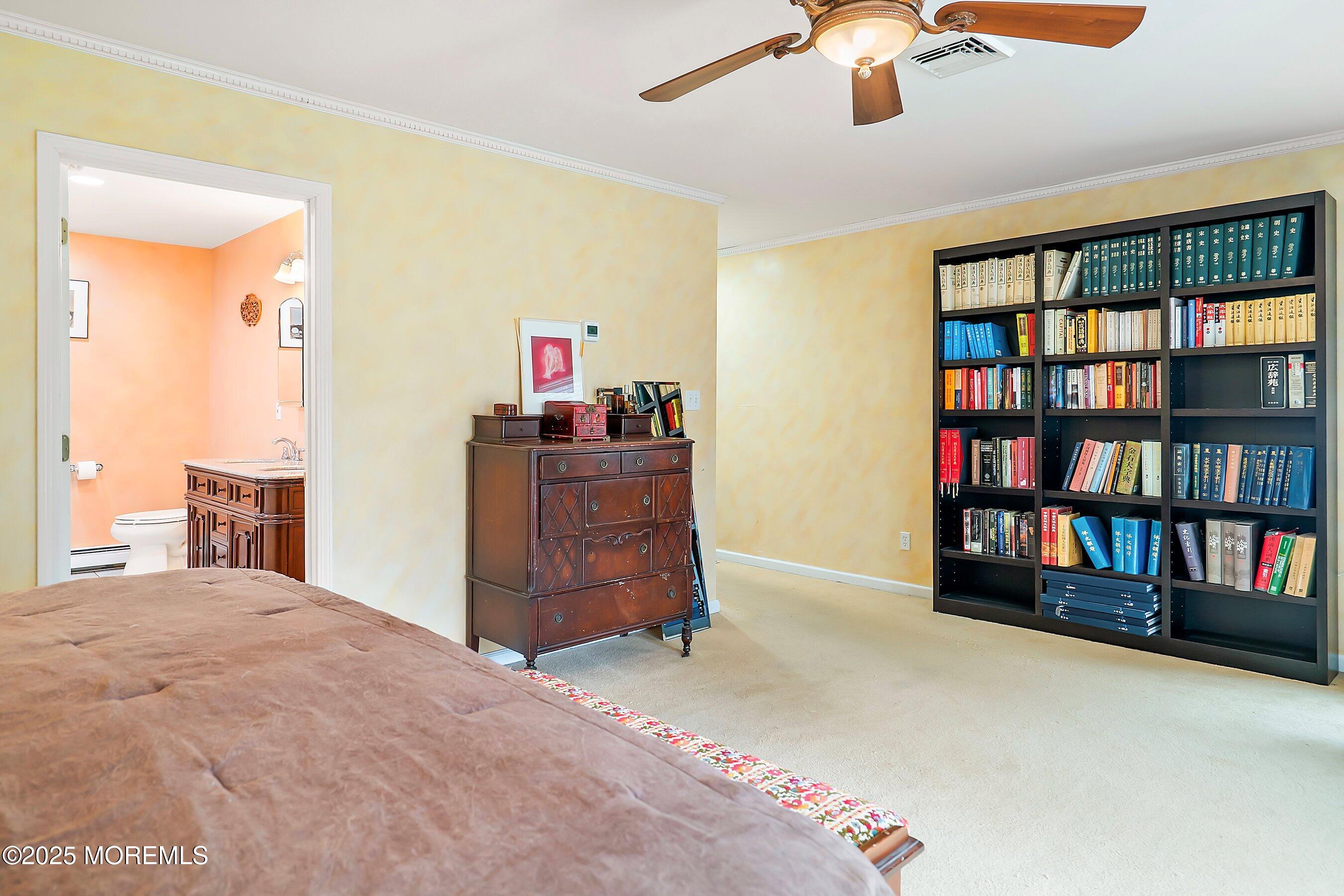29 Holland Road Middletown, NJ 07748 - Photo 21 of 59 a bedroom with a bed and a book shelf