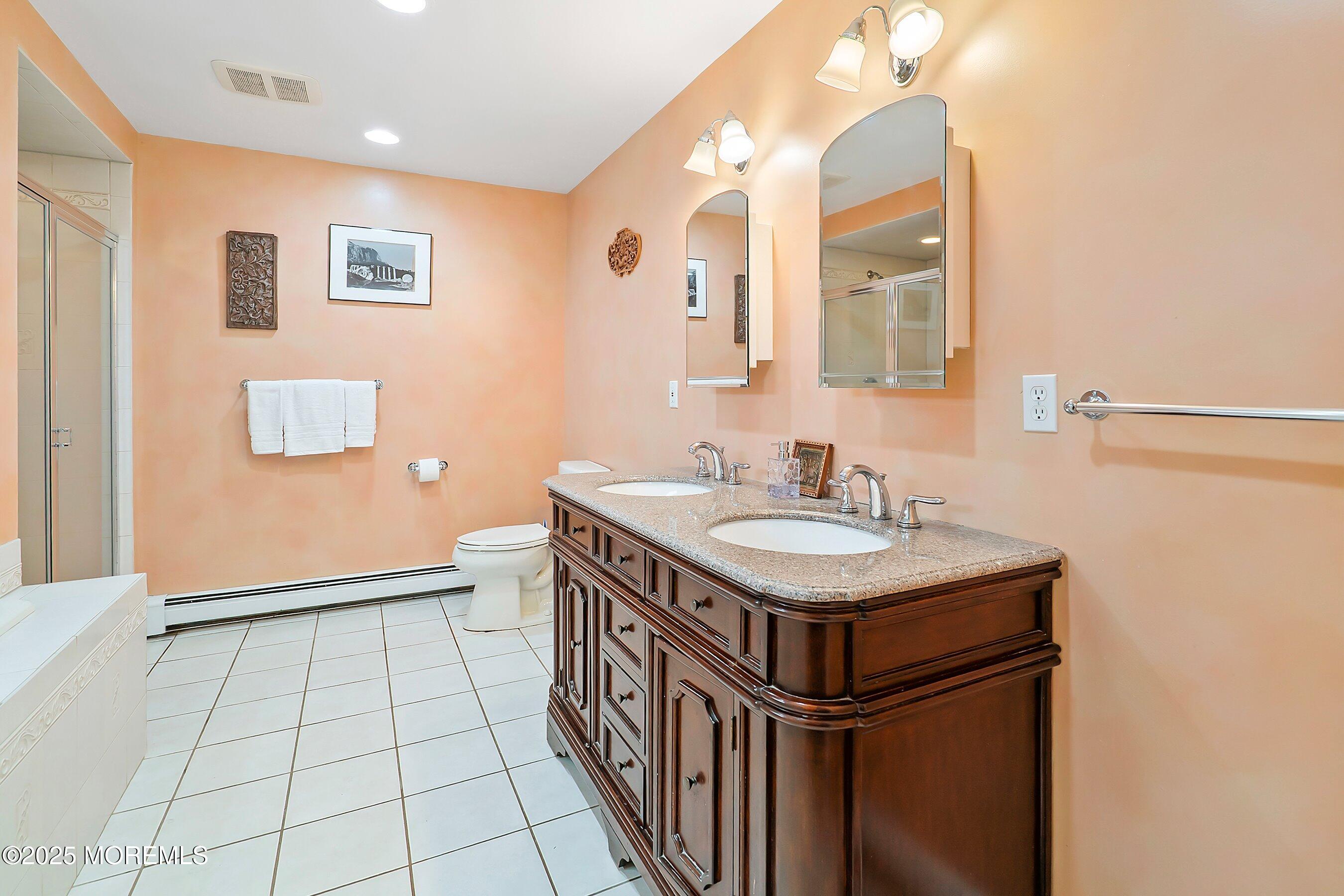 29 Holland Road Middletown, NJ 07748 - Photo 22 of 59 a bathroom with a sink a toilet a mirror and vanity