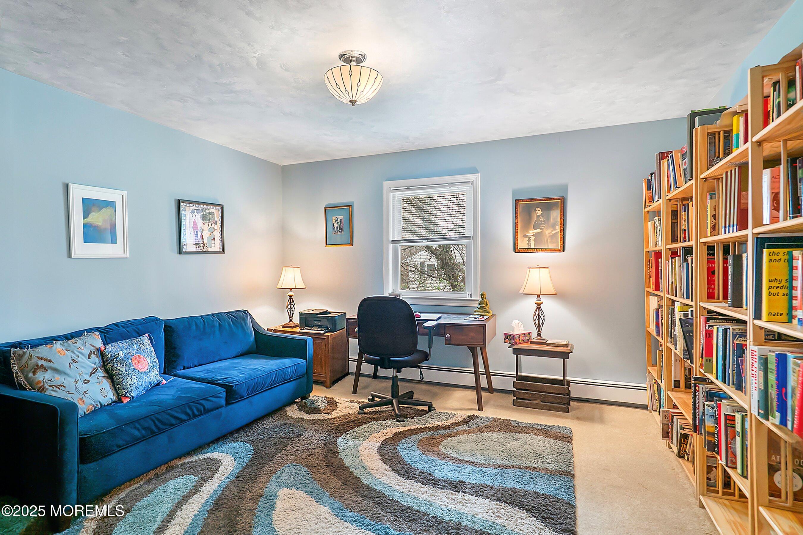 29 Holland Road Middletown, NJ 07748 - Photo 25 of 59 a living room with furniture a rug and a book shelf