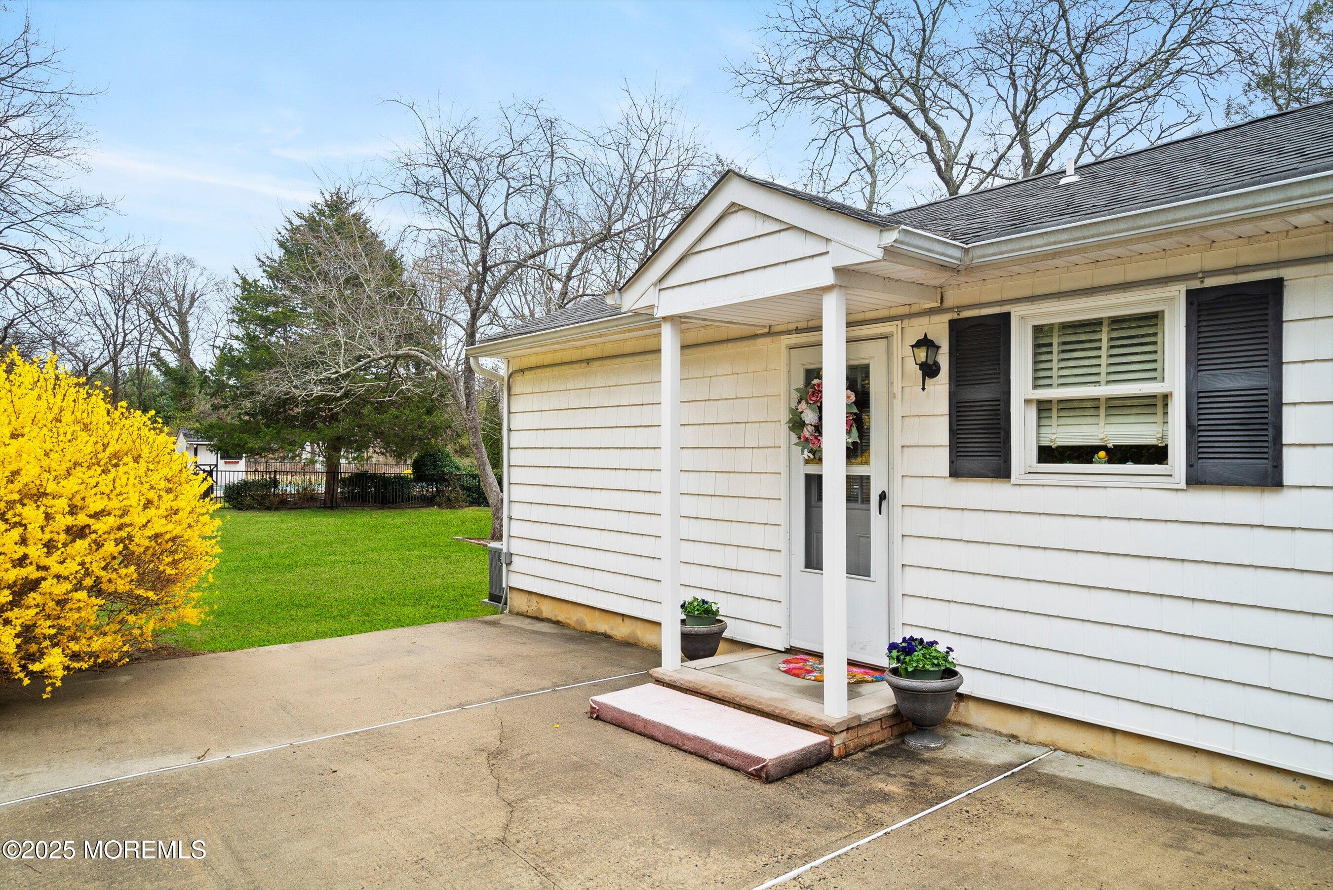 29 Holland Road Middletown, NJ 07748 - Photo 29 of 59 a view of a white house with a yard