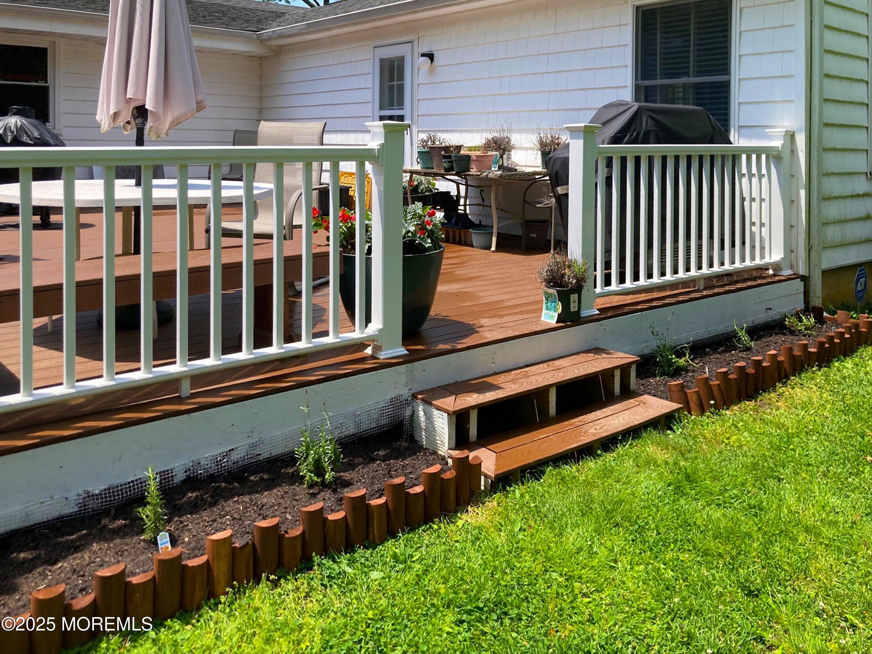 29 Holland Road Middletown, NJ 07748 - Photo 40 of 59 a view of a house with a small yard and wooden fence