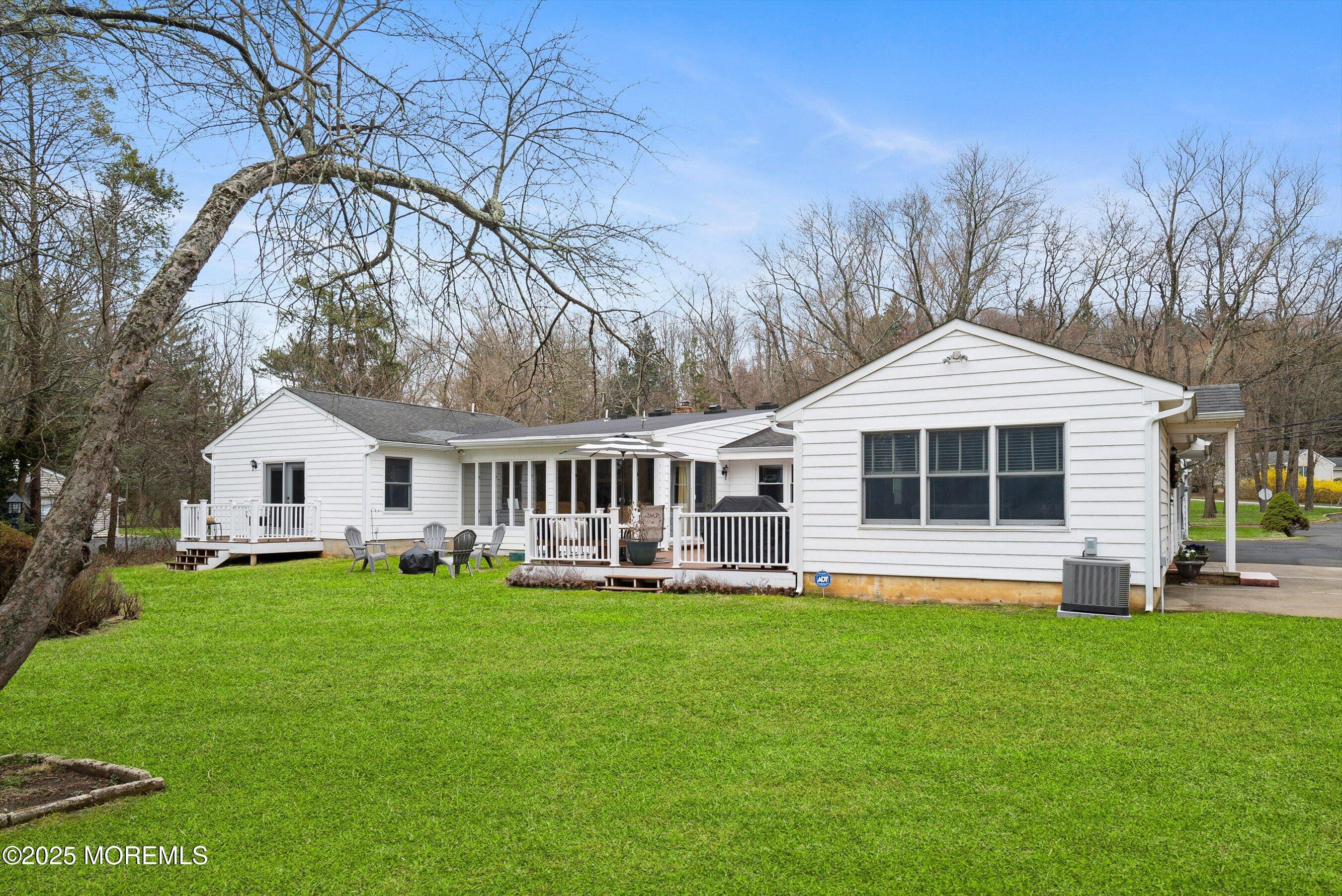 29 Holland Road Middletown, NJ 07748 - Photo 42 of 59 a front view of a house with a yard and trees