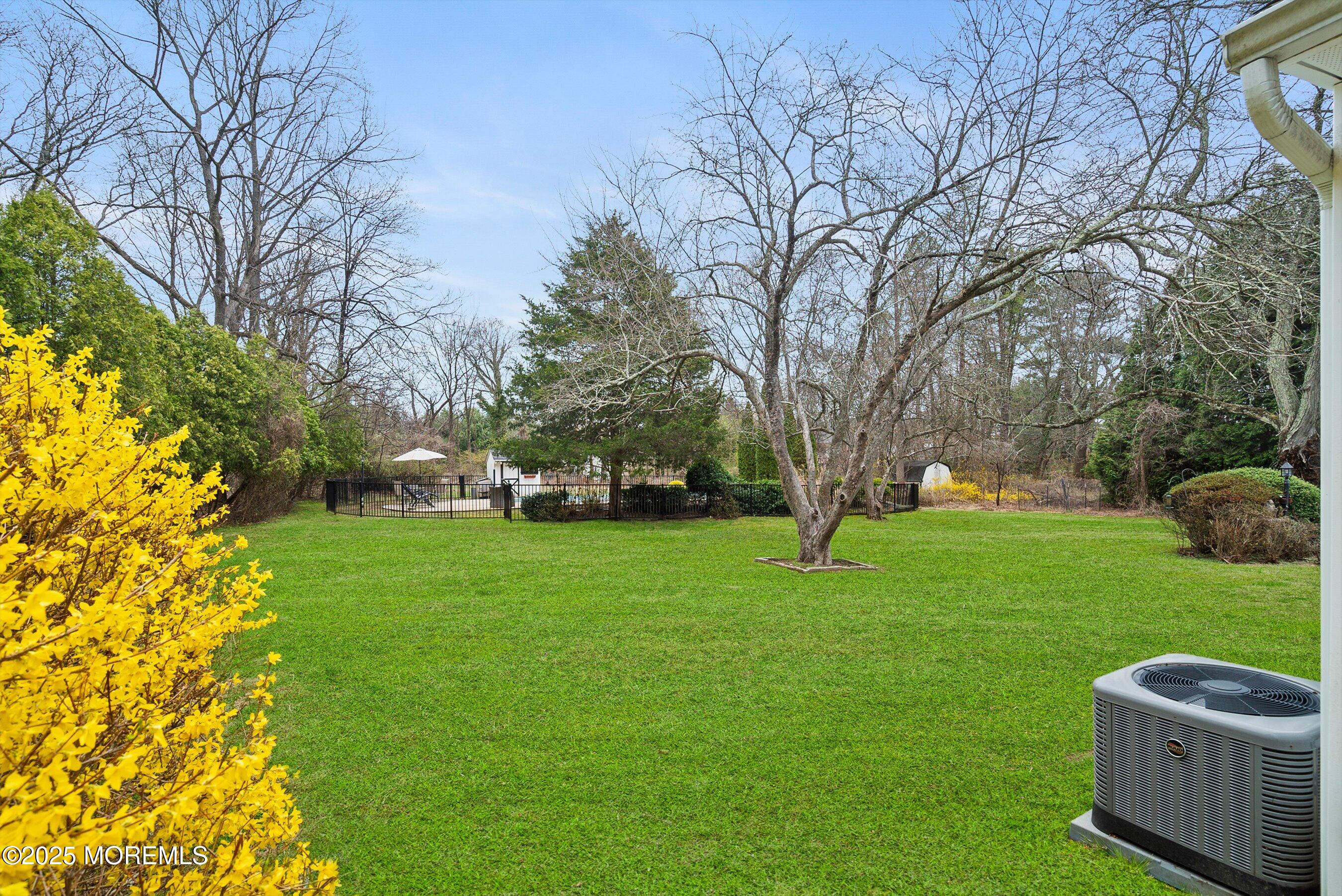 29 Holland Road Middletown, NJ 07748 - Photo 43 of 59 a backyard of a house with lots of green space and fountain