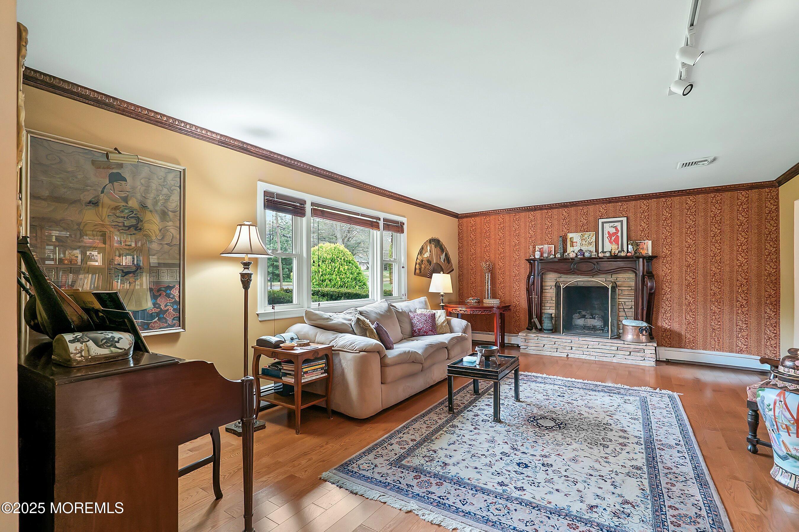 29 Holland Road Middletown, NJ 07748 - Photo 5 of 59 a living room with furniture large window and a fireplace