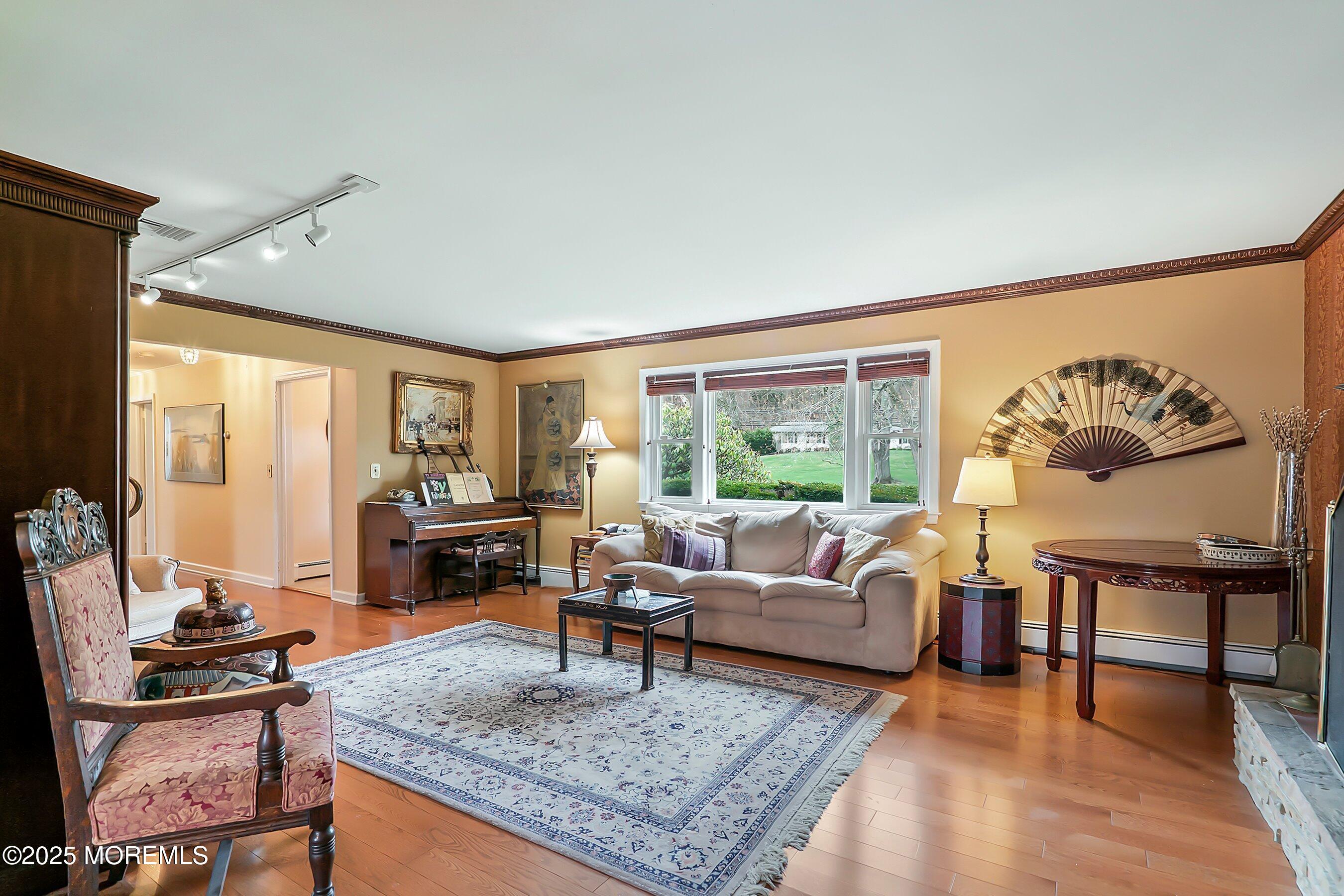 29 Holland Road Middletown, NJ 07748 - Photo 6 of 59 a living room with furniture and a table