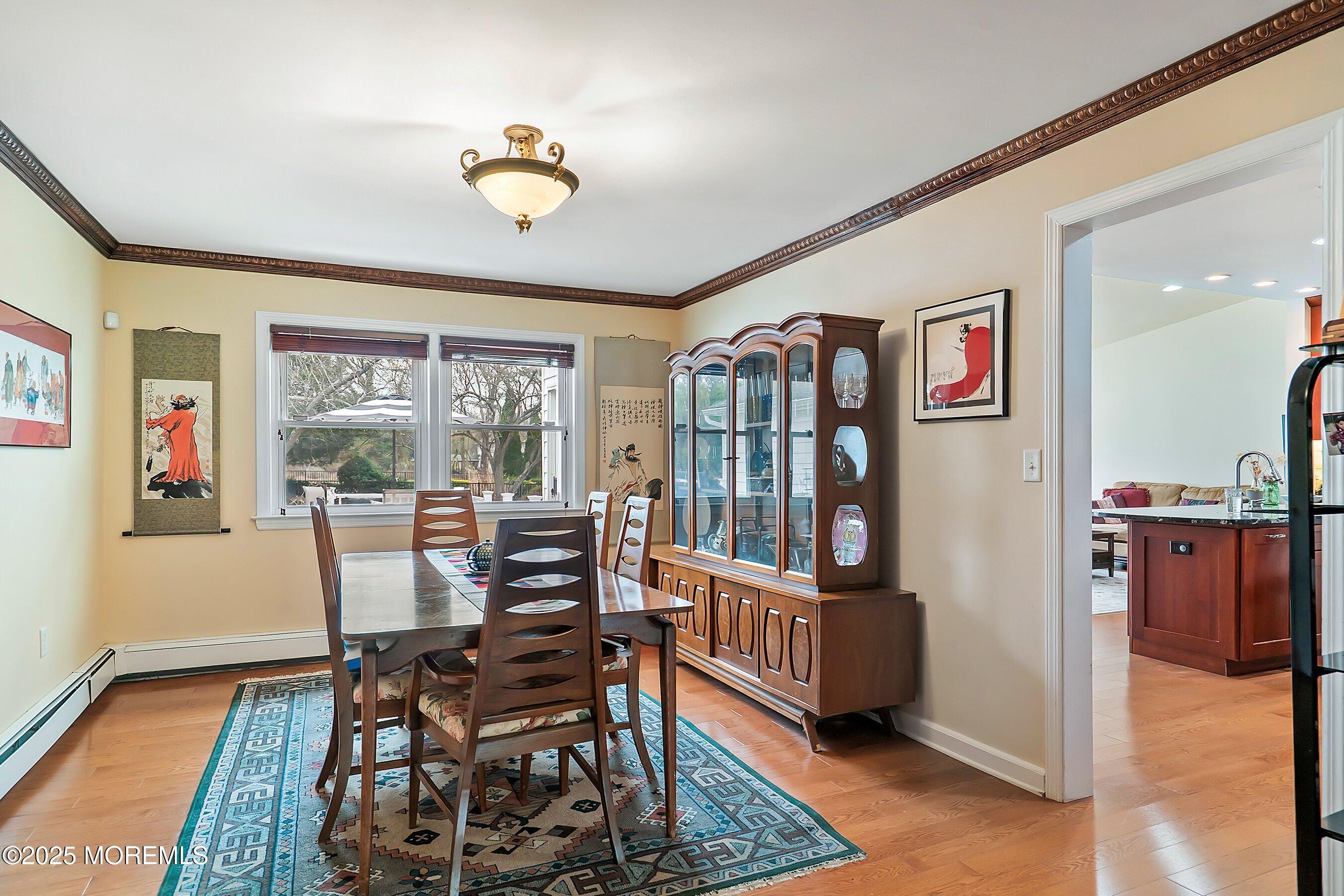 29 Holland Road Middletown, NJ 07748 - Photo 9 of 59 a dining room with furniture a rug and a wooden floor