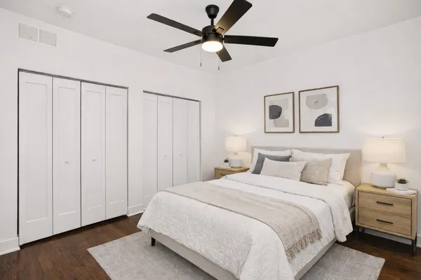 a bedroom with a bed and a ceiling fan