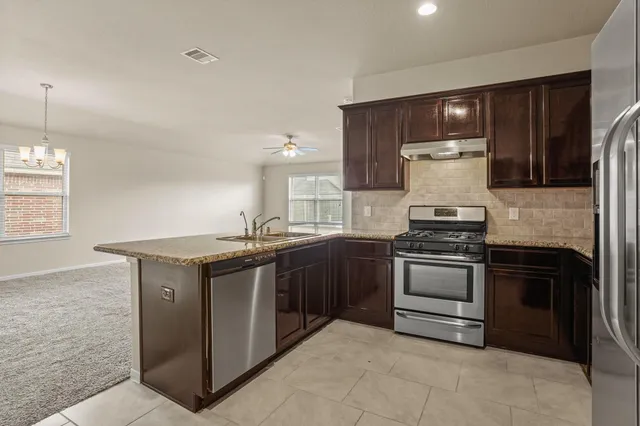 a kitchen with a stove and a refrigerator