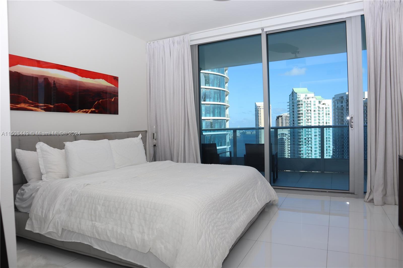 200 Biscayne Blvd Way, Unit 3205 Miami, FL 33131 - Photo 7 of 19 a bedroom with a bed and a television