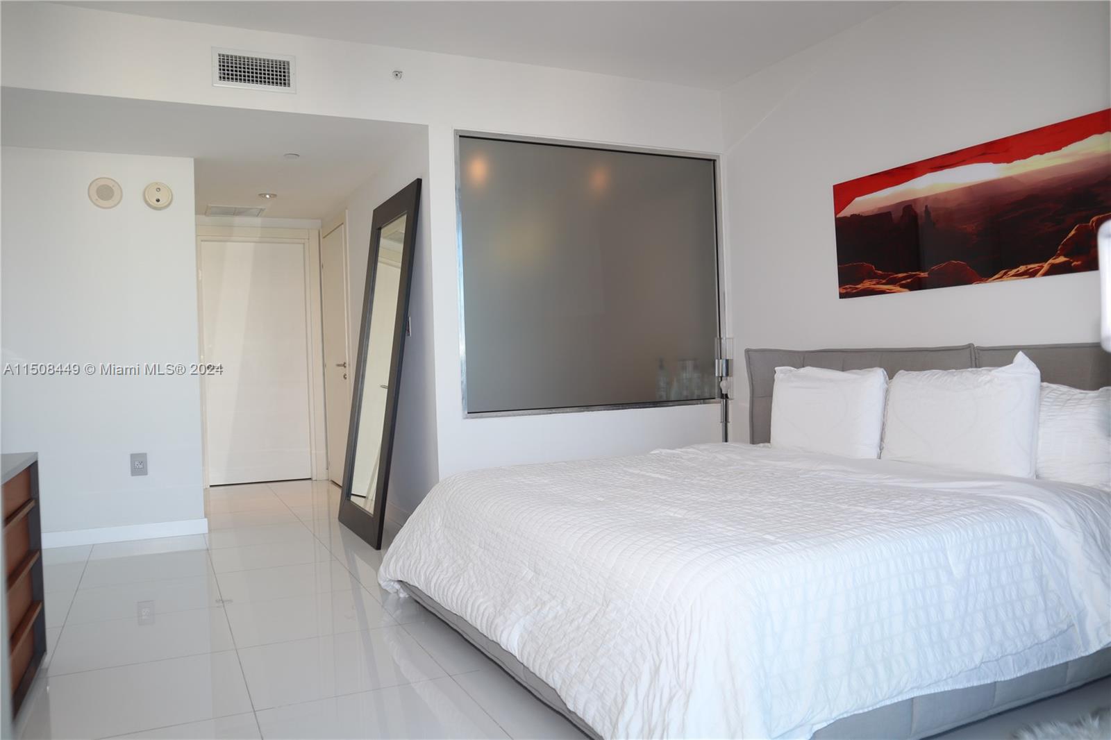 200 Biscayne Blvd Way, Unit 3205 Miami, FL 33131 - Photo 9 of 19 a bedroom with a bed and a flat screen tv