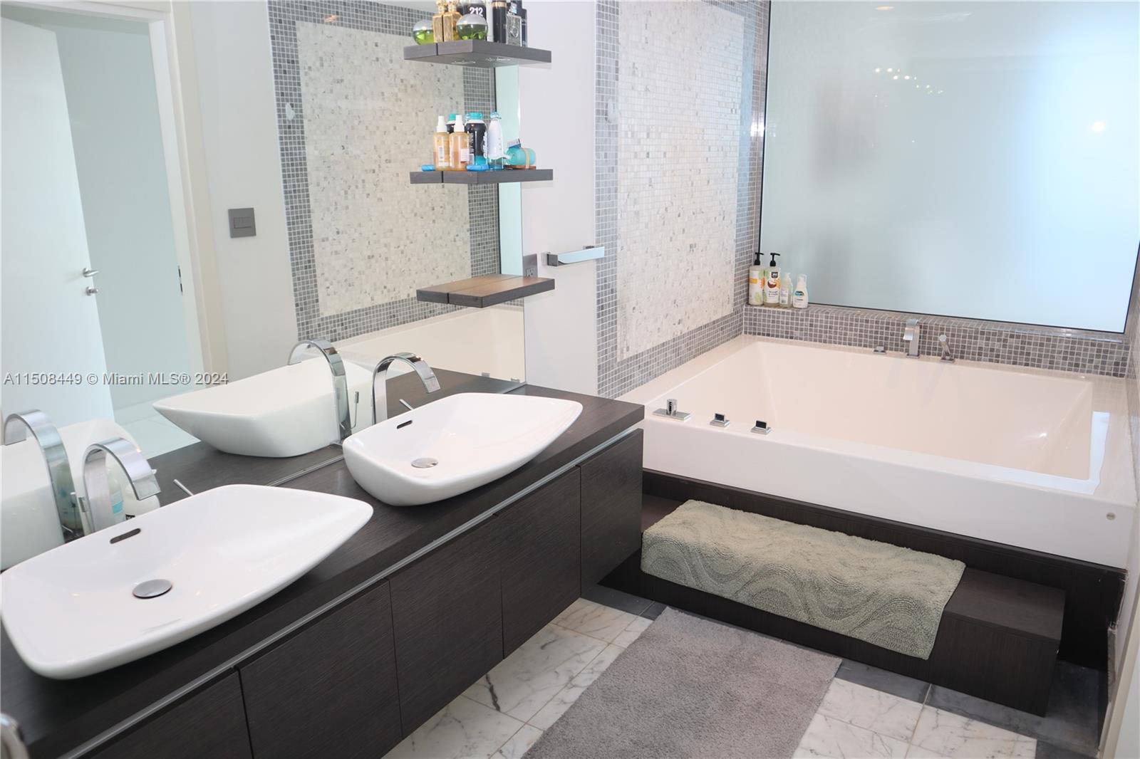 200 Biscayne Blvd Way, Unit 3205 Miami, FL 33131 - Photo 10 of 19 a bathroom with a double vanity sink and mirror