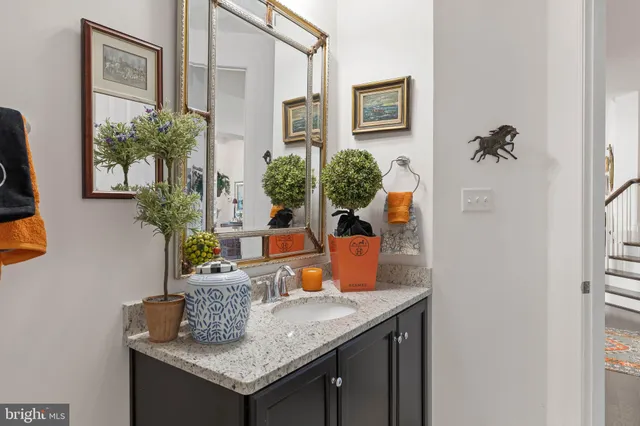 a kitchen with a granite countertop sink and a refrigerator
