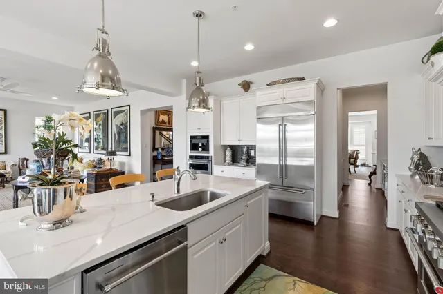 a kitchen with sink refrigerator and cabinets