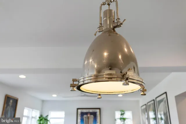 a room with a chandelier fan and a chandelier