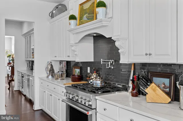 a kitchen with stainless steel appliances granite countertop a stove and cabinets