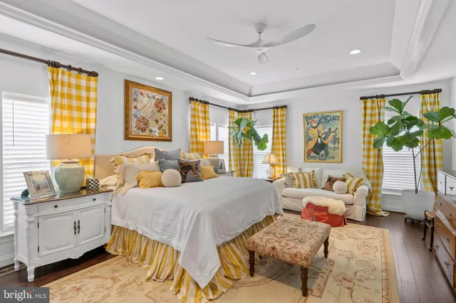 a bedroom with a bed and large windows