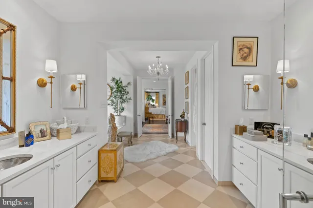 a spacious bathroom with a double vanity sink a mirror a vanity and next to a window