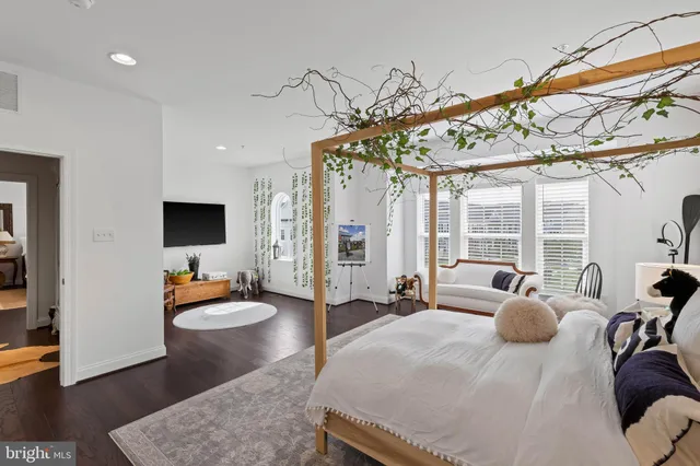 a bedroom with furniture and a flat screen tv