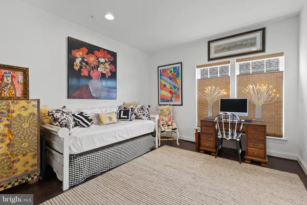 a living room with furniture a wooden floor and next to a window