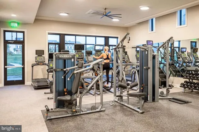a dining room with furniture and a floor to ceiling window