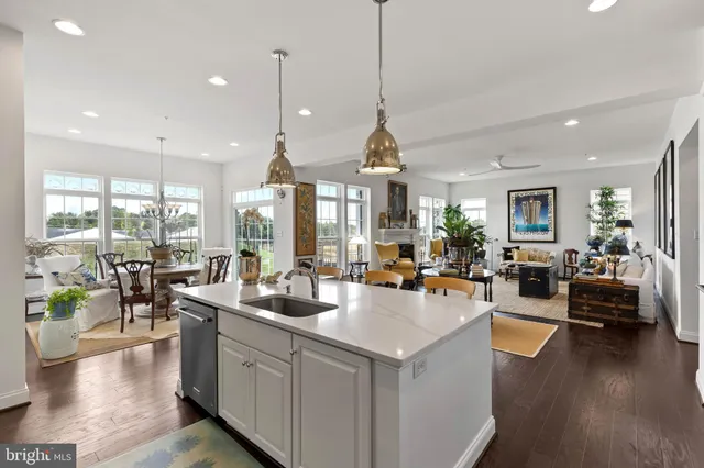 a very nice looking living room with dining room and wooden floor