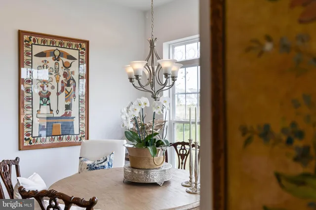 a dining room with furniture and potted plant