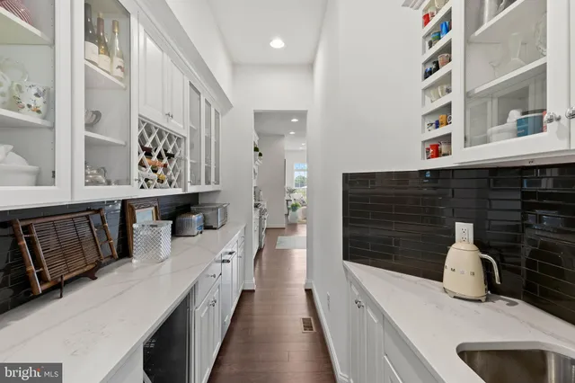a kitchen with stainless steel appliances a chimney and cabinets