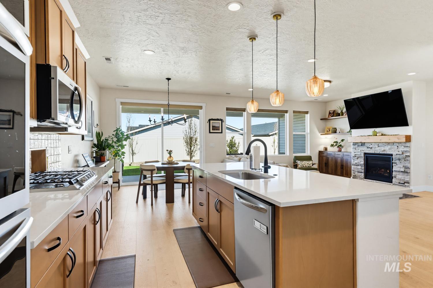5990 West Ladle Rpds Street Meridian, ID 83646 - Photo 16 of 42 Gourmet kitchen with stainless steel appliances, light wood-finish cabinetry, and a large island featuring a single-basin sink