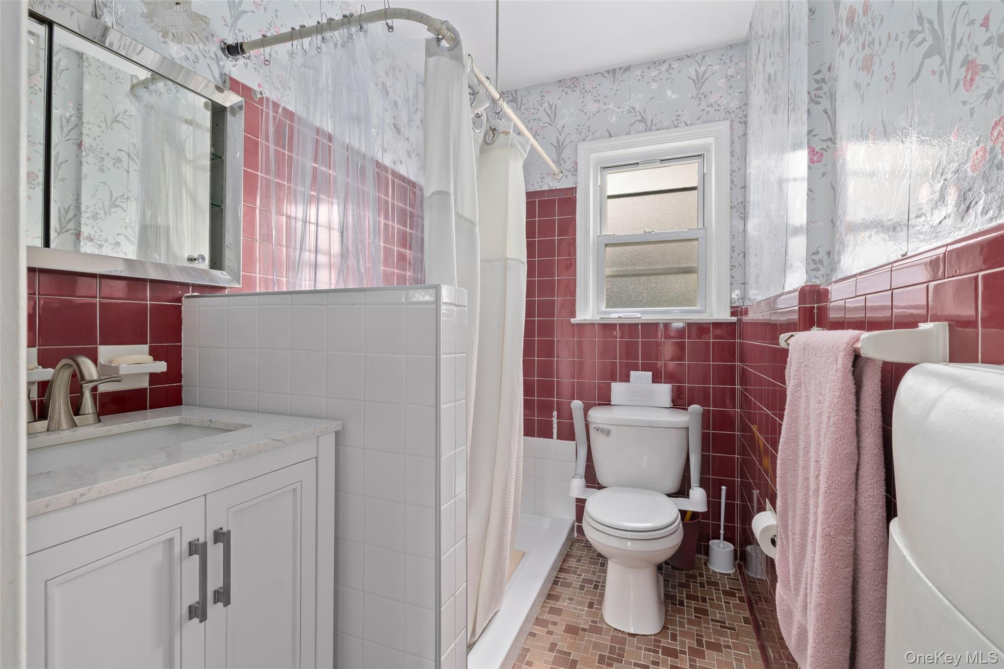 2975 Oceanside Road Oceanside, NY 11572 - Photo 12 of 26 a bathroom with a toilet sink and mirror